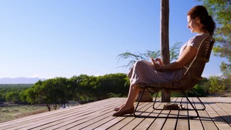 senior woman sitting on chair and using digital tablet 4k