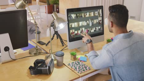 mixed race man working on computer in creative office