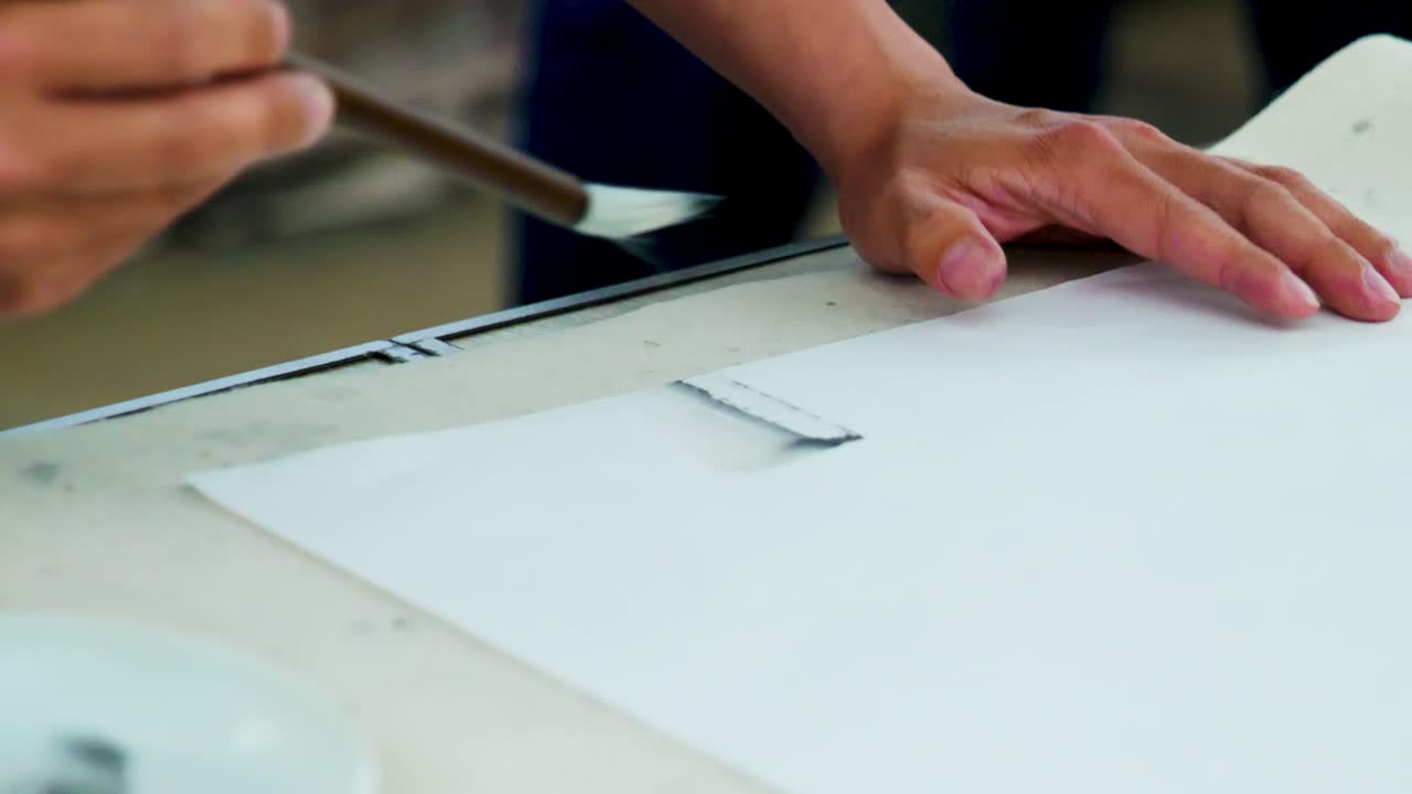 Slow Motion Footage of a Japanese Man Painting a Nihonga, a Traditional Japanese Painting, with Brushes and Black Ink