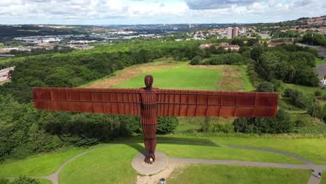 wide aerial view and flyover of the angel of the north statue in sunny conditions