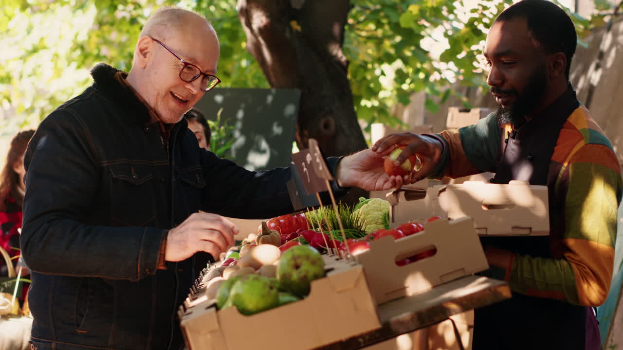People shopping for fruits and vegetables at an outdoor market