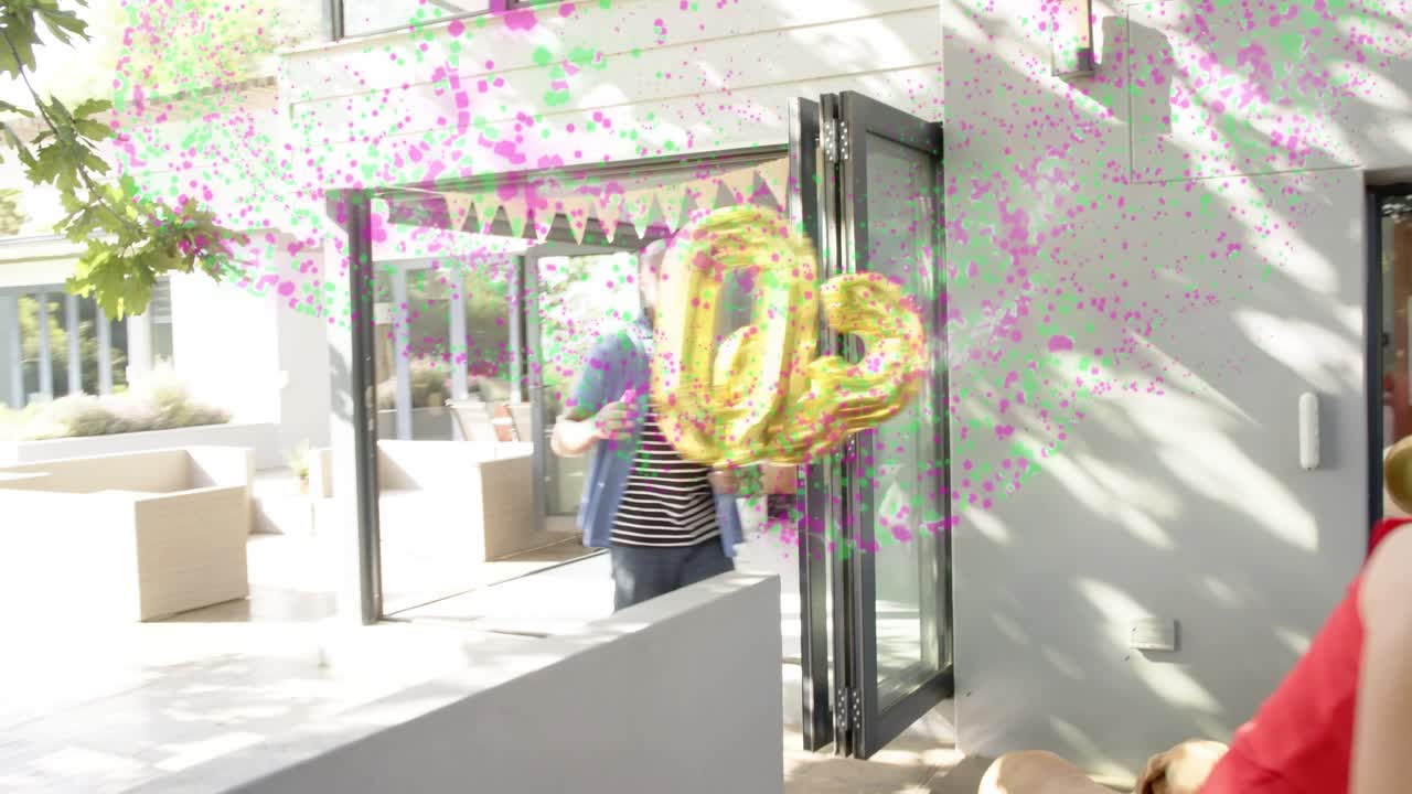 Man holding bowls walking from living-room to patio, bringing party food, confetti floating around