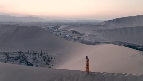 woman walking by sand dune