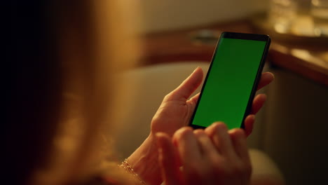 Closeup-hand-touching-green-screen-device.-Woman-scrolling-chroma-key-gadget.