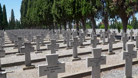 gravestones of serbian soldiers stretch in uniform rows at zeitenlik military cemetery in thessaloniki, honoring those who perished during world war i among cypress trees and solemn surroundings