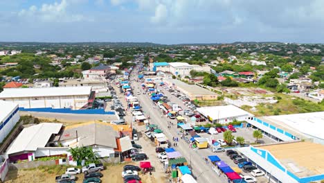 panoramic aerial overview above parked cars and tent shades along street for carnaval grand march curacao