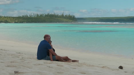 adult caucasian couple enjoy ocean view on maré, loyalty islands, new caledonia