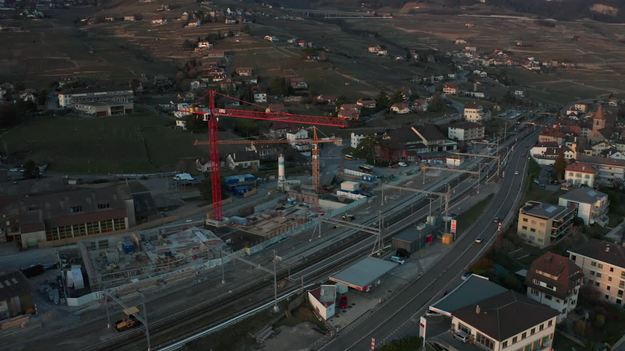 Aerial of large cranes at suburban construction site