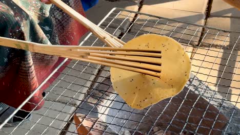 rice cracker grilling on open flame in thailand