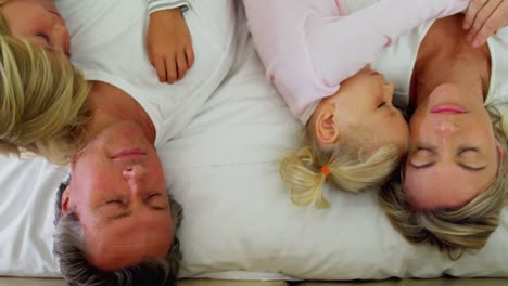 family sleeping on bed in the bed room 4k