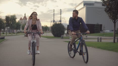 couple cycling in a city park