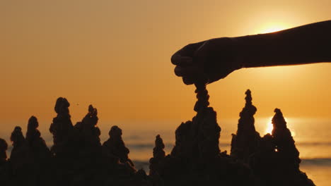 Child's-Hand-Builds-A-Sand-Castle-On-The-Beach-4K-Video