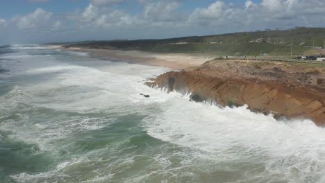 Aerial-overview-of-waves-slamming-into-cliff