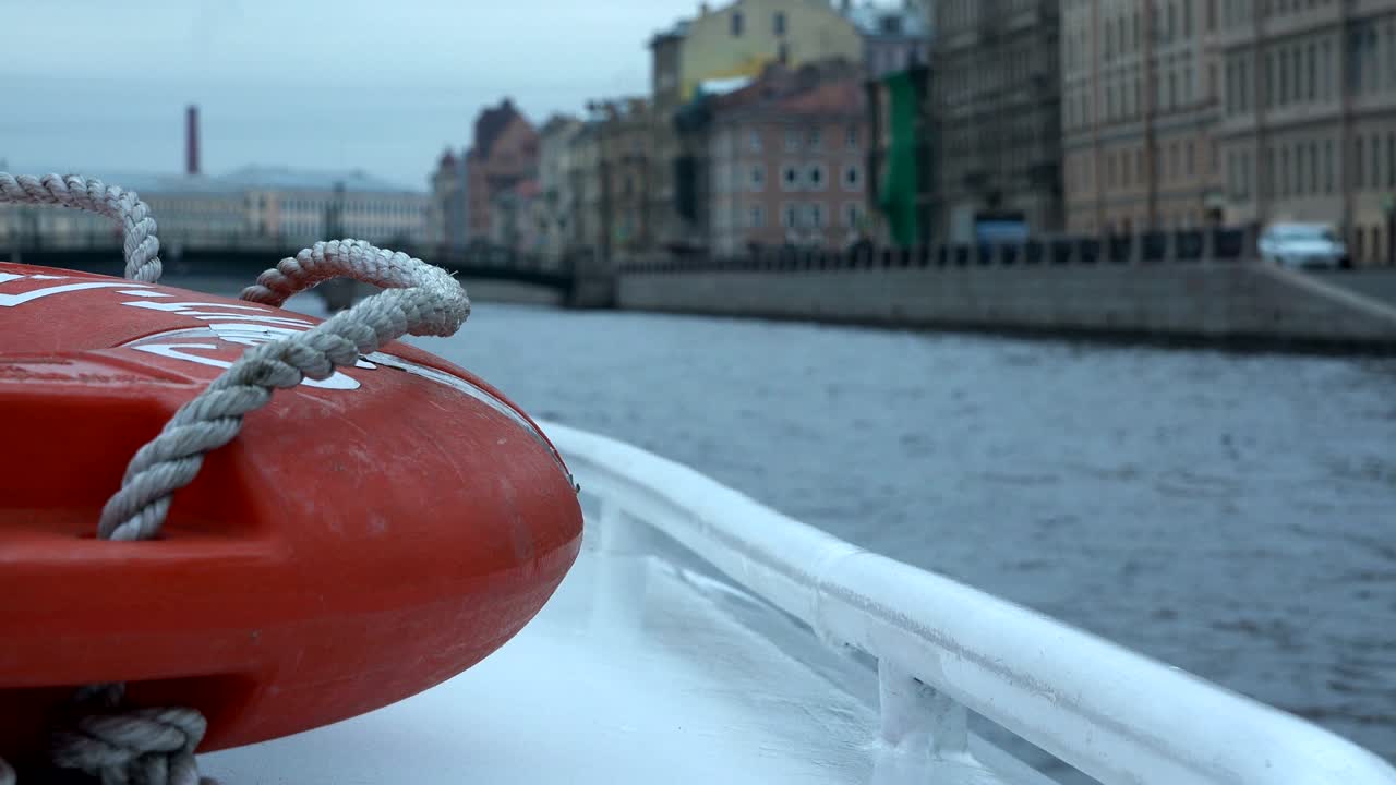 city embankment at sunset day view from the river ship