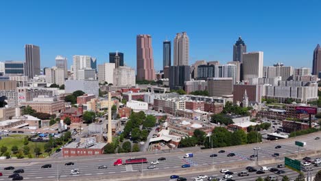 drone shot pulling out from downtown atlanta and panning to reveal midtown on a summer day