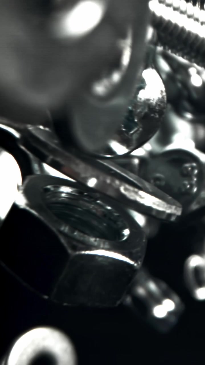 Shiny Metal Bolts, Nuts, and Washers Falling in Slow Motion