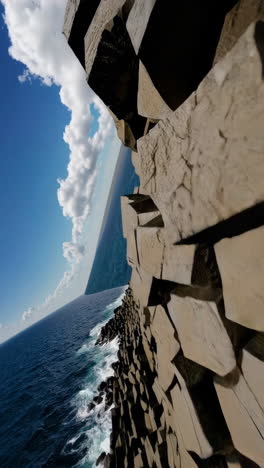 abstract composition of stacked geometric forms against a blue sky