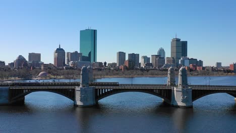 aerial establishing city skyline of boston massachusetts with longfellow bridge and subway train crossing 1