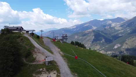 an aerial shot of a ski lift in the french alphs during the summer