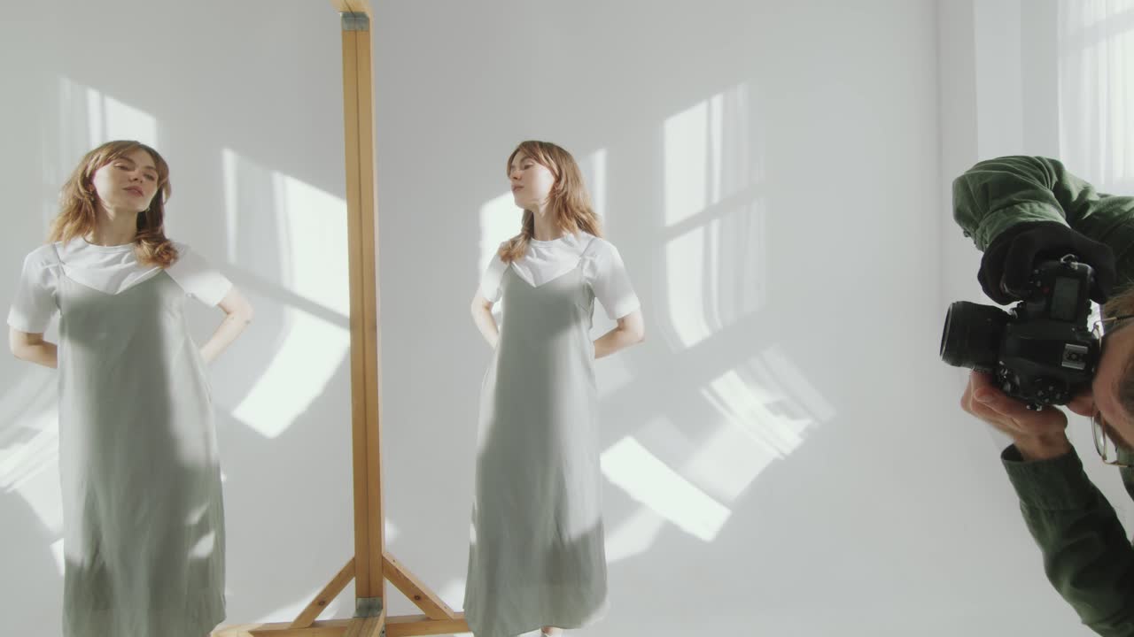 Photographer Capturing Image of Woman Posing in front of Mirror in Studio