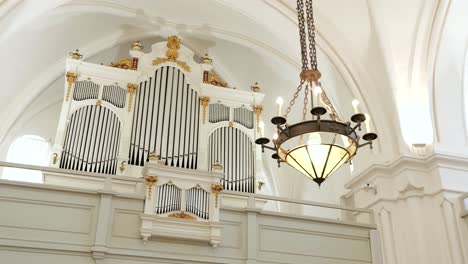 chandelier, pipes of pipe organ in front of lutheran church