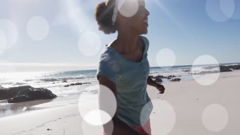 Animation-of-spots-over-african-american-couple-at-beach