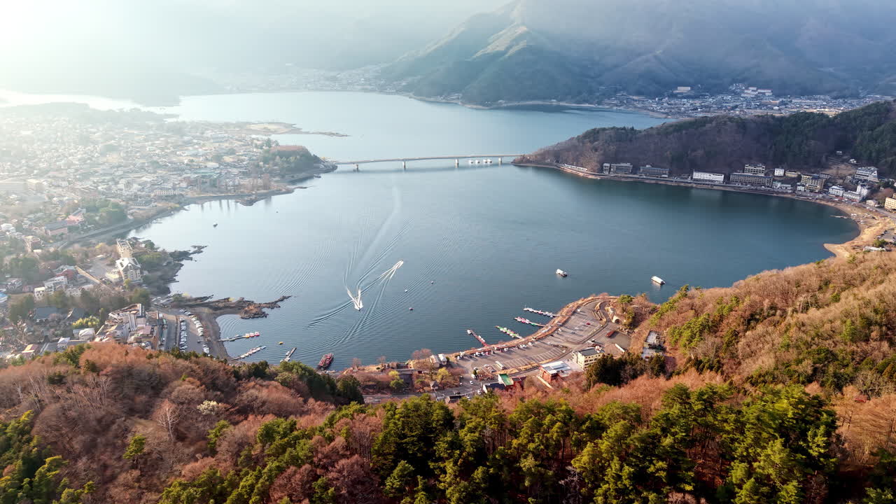 Aerial drone view of boats moving on Lake Kawaguchiko near the Fujikawaguchiko town, Japan