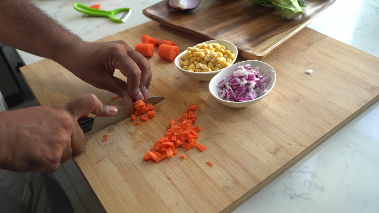 Man Chopping Carrots and Preparing Vegetables for Cooking