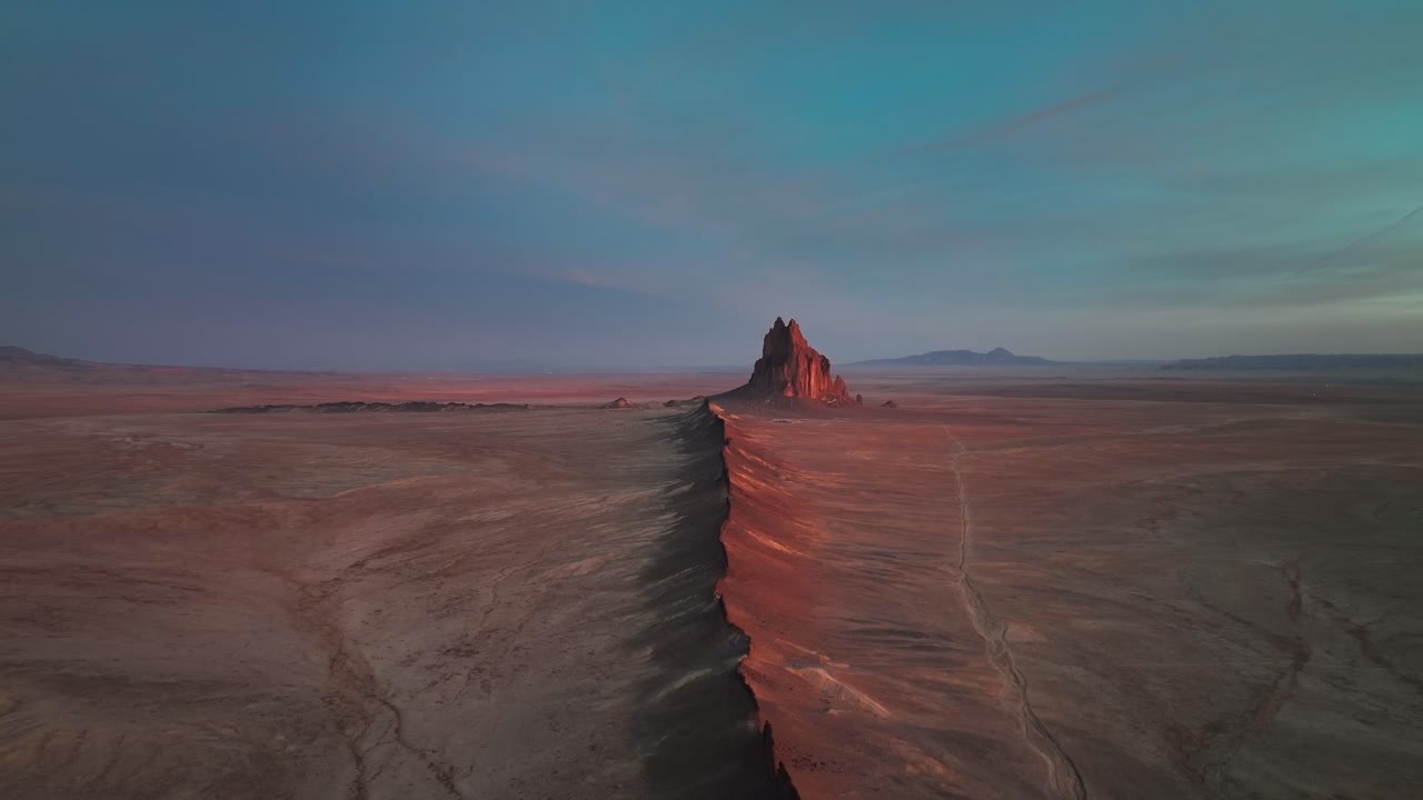 shiprock iluminado al atardecer en nuevo méxico, estados unidos - toma aérea de drones