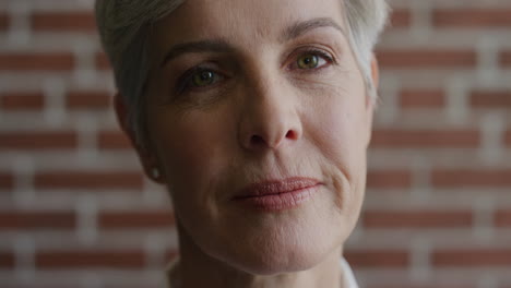 close up portrait beautiful middle aged woman thinking contemplative turns head elegant senior female looking calm at camera slow motion aging beauty