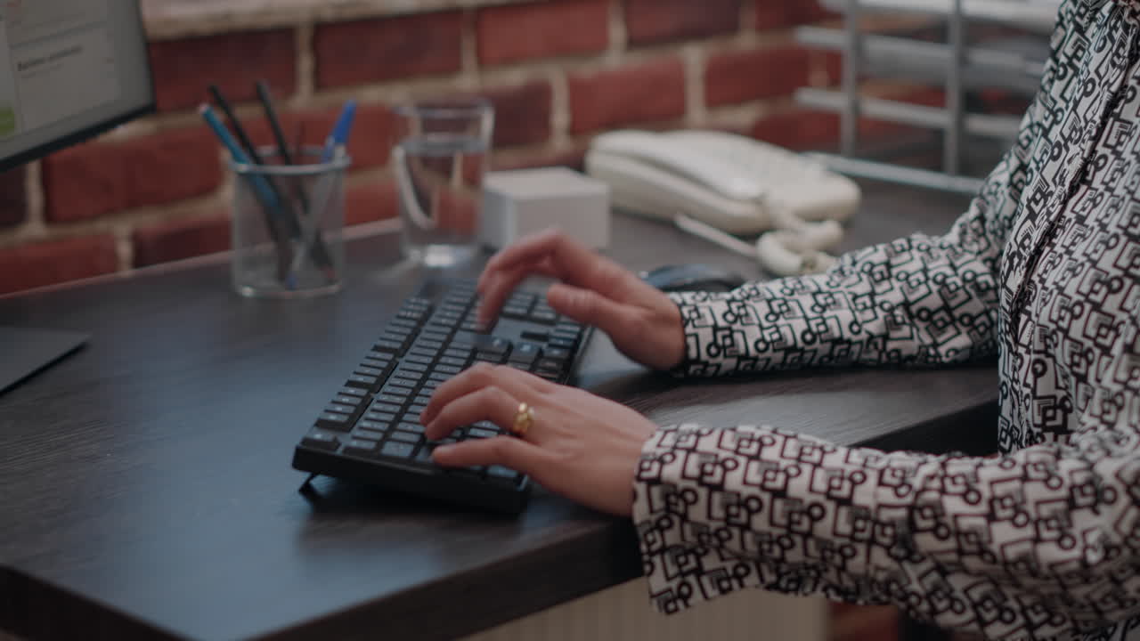 Close up of entrepreneur typing on computer keyboard