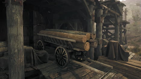 rustic wooden cart with logs in front of an old shed