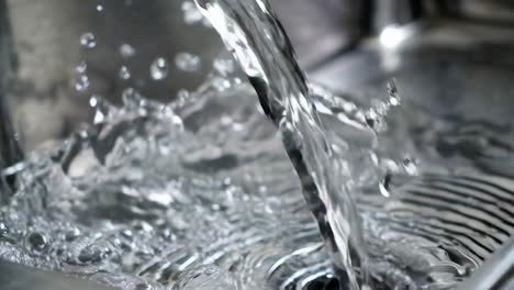 water flowing from a faucet into a sink