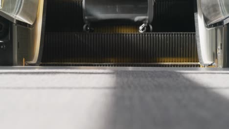 Businesswoman-on-an-escalator-in-a-modern-building