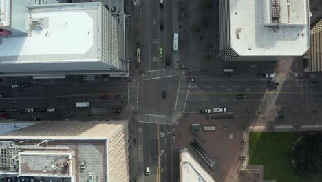 Overhead-Aerial-Shot-of-Downtown-Oakland-intersection-as-cars-pass-by,-Bay-Area-California-Commute