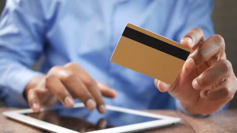 man using tablet for online payment with credit card