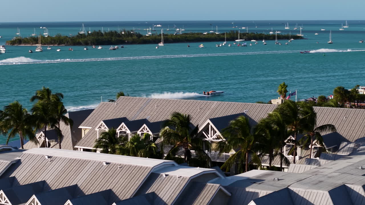 Powerboat driving on the coastline of Key West, sunny Florida, USA - Aerial view