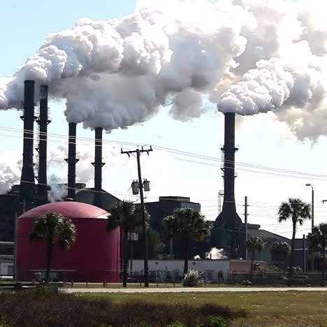 a power plant with smokestacks belches smoke into the air 1