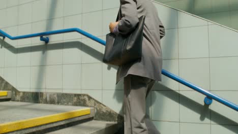 woman walking upstairs in subway station