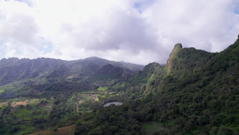 Vista-Aérea-De-Un-Exuberante-Valle-Verde-Con-Un-Pico-De-Montaña-Y-Un-Lago,-Cielo-Nublado-Arriba-En-San-Carlos