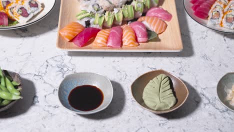a rising shot showcasing a variety of sushi rolls, highlighting different types of sushi. ideal for presenting assorted sushi varieties and japanese cuisine in food displays or restaurant menus.