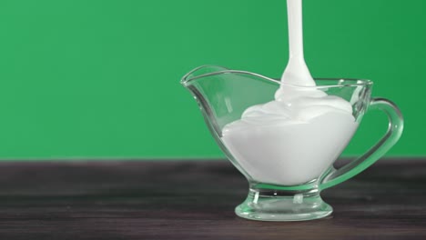 sour cream is poured into a glass dish.