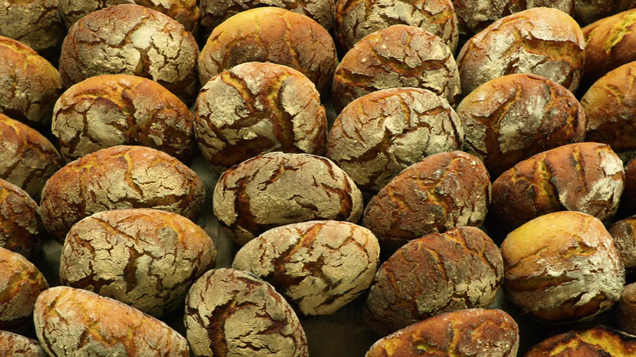 Bakery Rack Full Of Sourdough Bread Buns - top view, slider shot