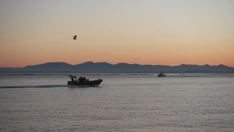 speedboat on fraser river at sunset, steveston, british columbia waterfront