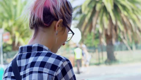 Stylish-woman-in-hair-bun-walking-outdoors-4k