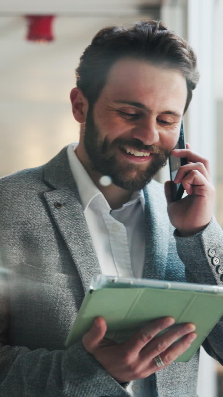 Happy Businessman Talking on Phone and Using Digital Tablet
