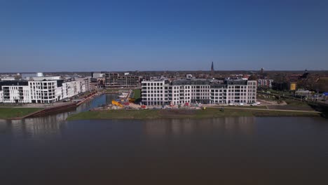 meadow floodplains aerial reveal on kade zuid apartment complex new housing construction project part of urban development in zutphen with noorderhaven neighbourhood along river ijssel