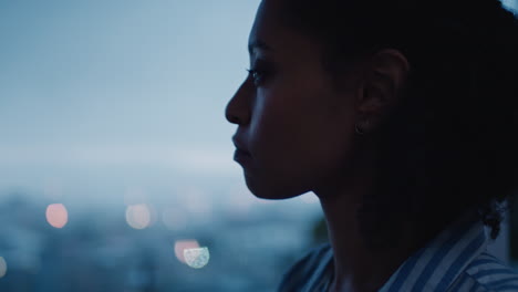 beautiful business woman looking out window in hotel room at sunset planning ahead successful independent female contemplating future enjoying calm evening