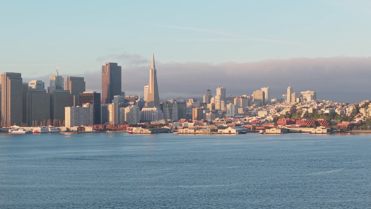 Towering skyscrapers rise along the San Francisco waterfront in this crisp aerial shot full of urban rhythm.