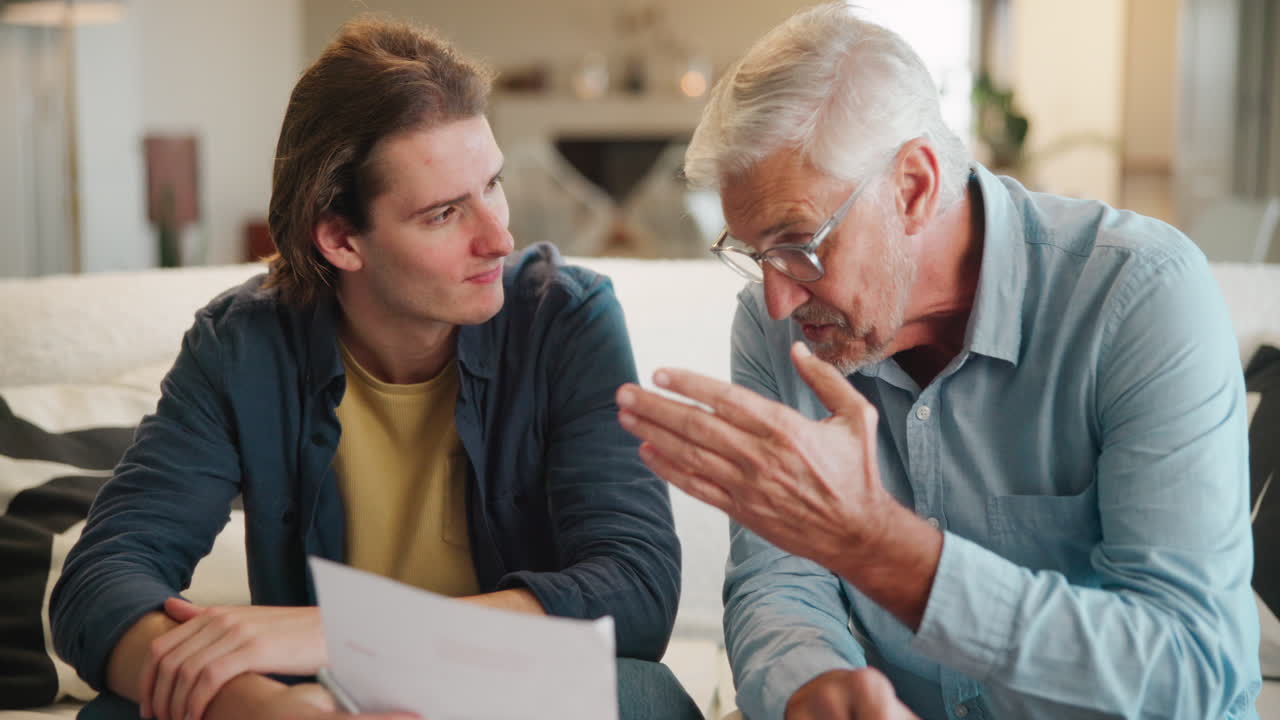 Padre e figlio che discutono documenti a casa